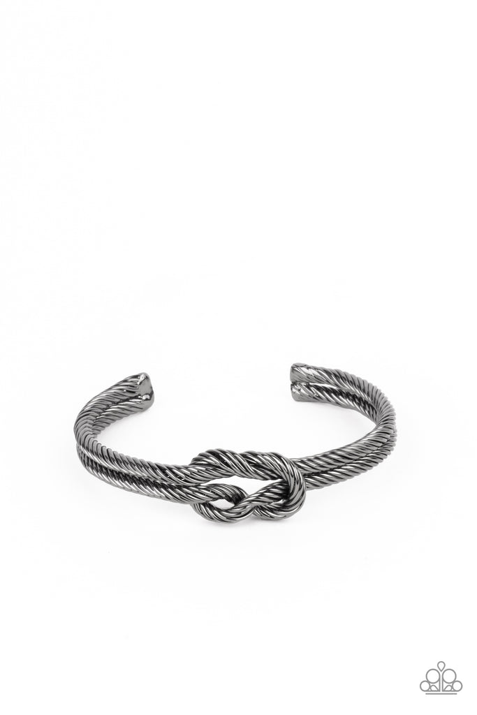 Gritty gunmetal cable-like bars curl around the wrist, knotting into an edgy cuff for a bold industrial look.  Sold as one individual bracelet.  