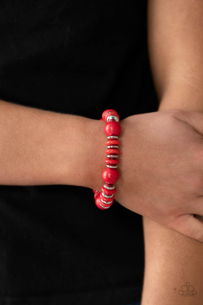 Disc shaped red stone and silver beads join oversized red stone beads along a stretchy band, creating a rustic centerpiece around the wrist.  Sold as one individual bracelet.