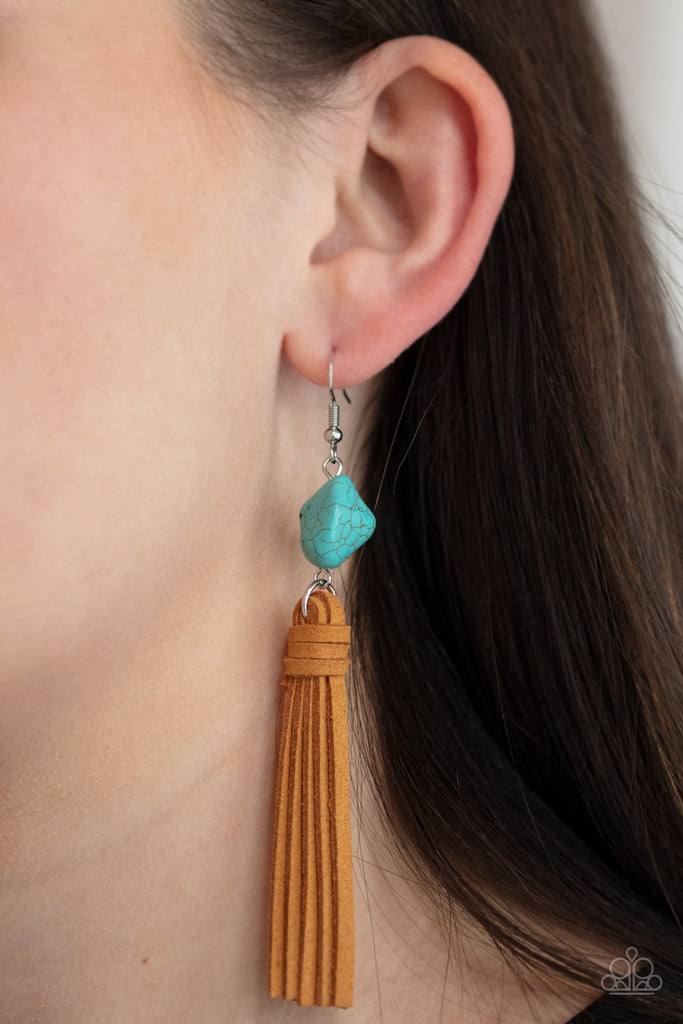 A rustic brown suede tassel swings from the bottom of an imperfect turquoise stone, creating an earthy centerpiece. Earring attaches to a standard fishhook fitting.  Sold as one pair of earrings.