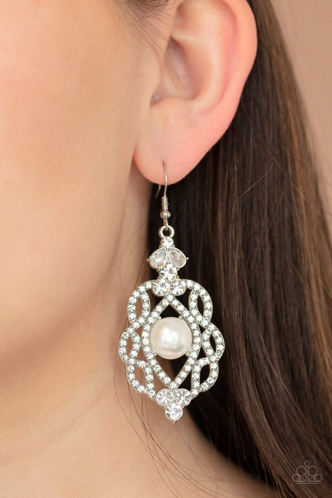 White rhinestone encrusted silver bars interloop around a pearly white beaded center, coalescing into a regal lure. Earring attaches to a standard fishhook fitting.  Sold as one pair of earrings.