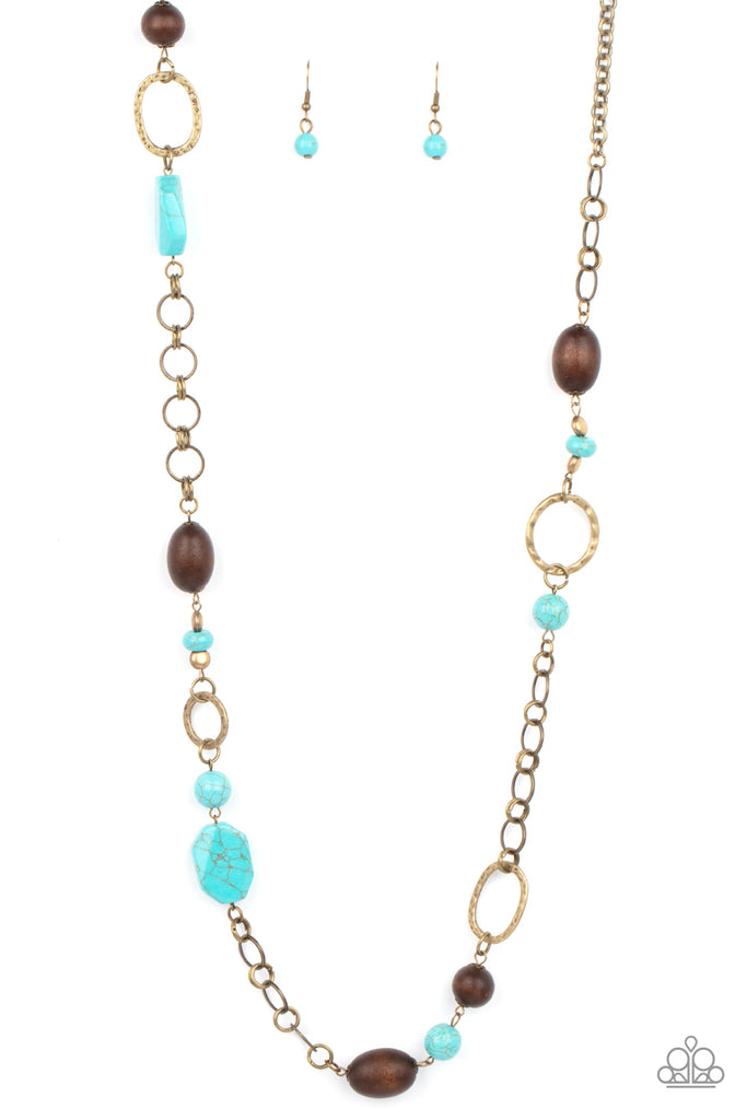 prairie-reserve-brass  A mismatched assortment of turquoise stones, wooden beads, and brassy accents sporadically adorn a brass double-linked chain, creating an earthy display across the chest. Features an adjustable clasp closure.  Sold as one individual necklace. Includes one pair of matching earrings.