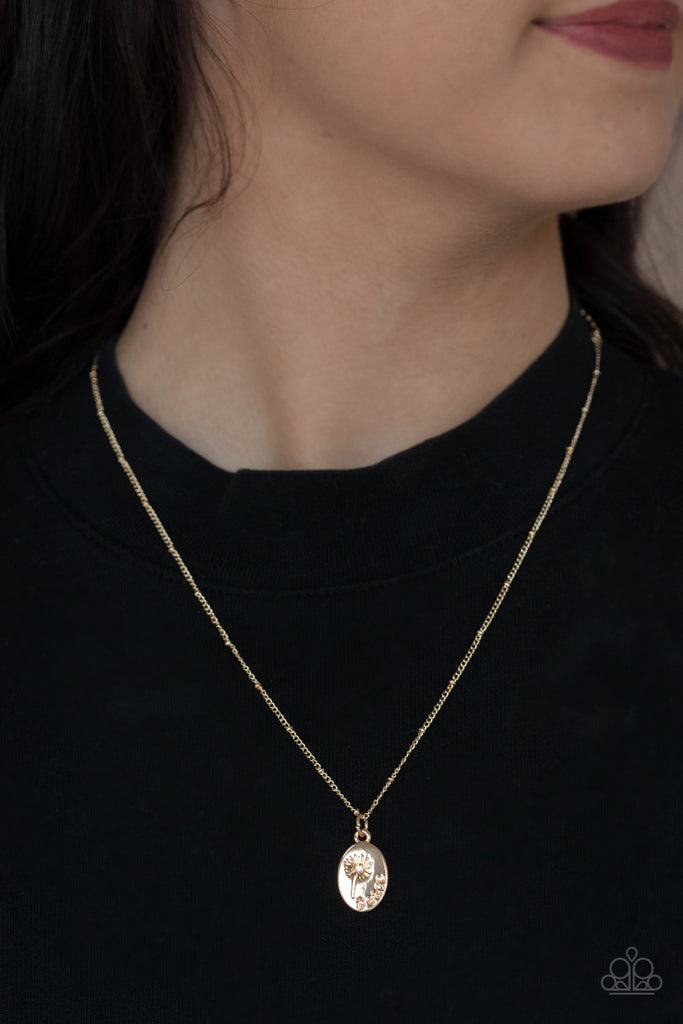 Featuring a blooming dandelion, a shiny gold disc is stamped in the word, "Peace," creating a whimsical pendant below the collar. Features an adjustable clasp closure.  Sold as one individual necklace. Includes one pair of matching earrings.