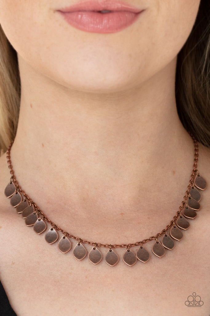 Teardrop copper discs drip from a dainty copper chain, creating a rustic fringe below the collar. Features an adjustable clasp closure.  Sold as one individual necklace. Includes one pair of matching earrings.