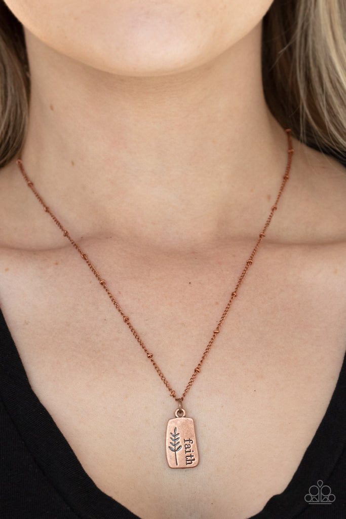 Stamped in a leafy accent, an asymmetrical copper plate is stamped in the word, "Faith," creating a dainty pendant below the collar. Features an adjustable clasp closure.  Sold as one individual necklace. Includes one pair of matching earrings.