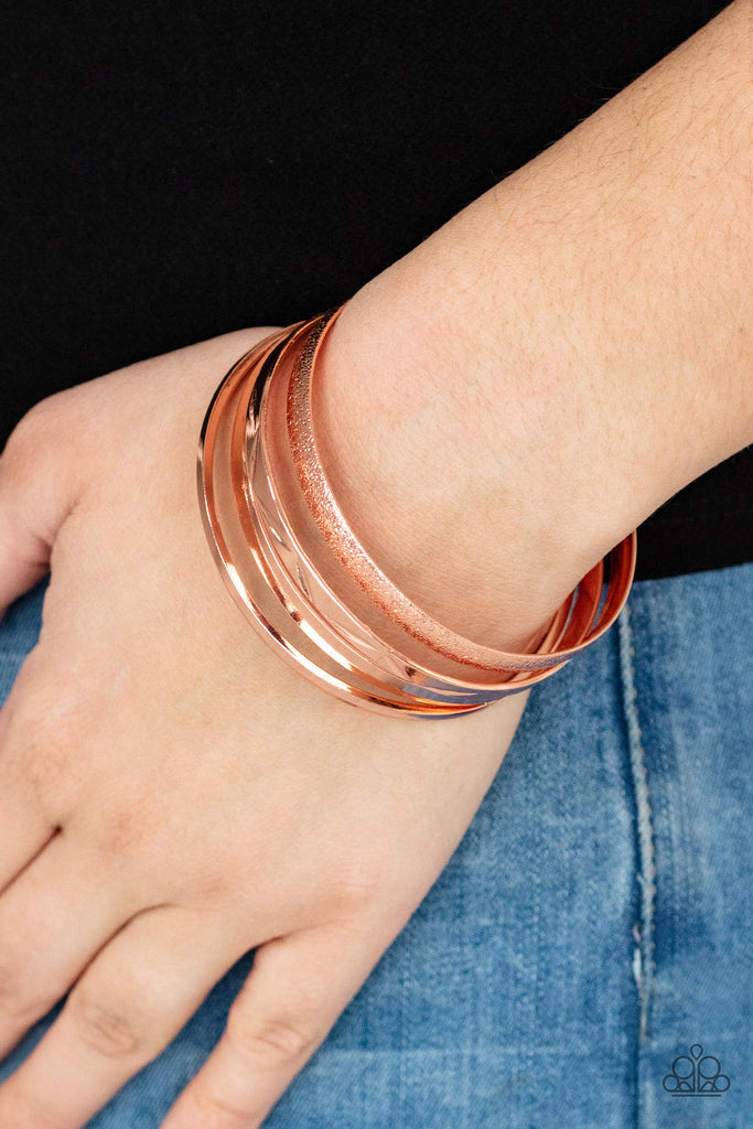 Varying in hammered, textured, and high sheen finishes, a mismatched collection of shiny copper bangles stacks across the wrist for a classic fashion.  Sold as one set of five bracelets.