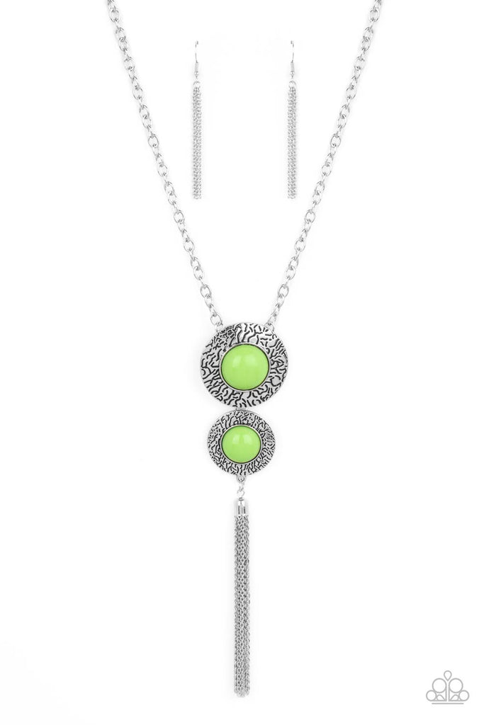 Stamped in vein-like patterns, two oversized silver discs are dotted with bubbly green beaded centers at the bottom of a chunky silver chain. A shimmery silver chain tassel swings from the bottom of the stacked pendant, adding playful movement. Features an adjustable clasp closure. Features an adjustable clasp closure.  Sold as one individual necklace. Includes one pair of matching earrings.