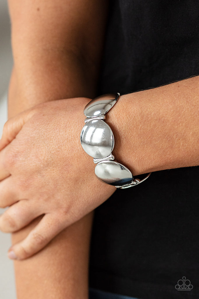 Infused with curved bar-like accents, a shiny series of beveled silver discs are threaded along stretchy bands around the wrist for a bubbly metallic look.  Sold as one individual bracelet.  New Kit