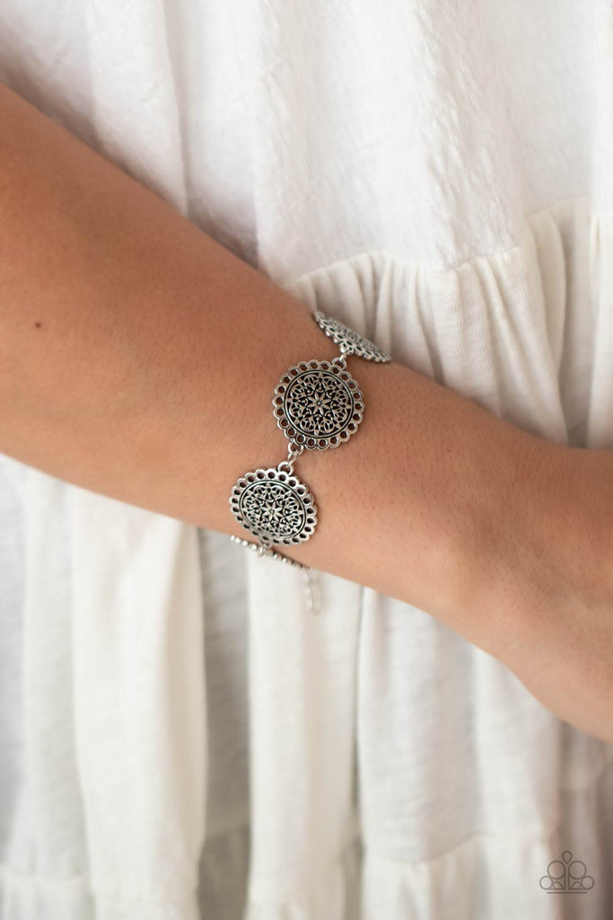 Filled with floral filigree, scalloped silver frames dotted in airy trims delicately link around the wrist for a whimsically seasonal look. Features an adjustable clasp closure.  Sold as one individual bracelet.