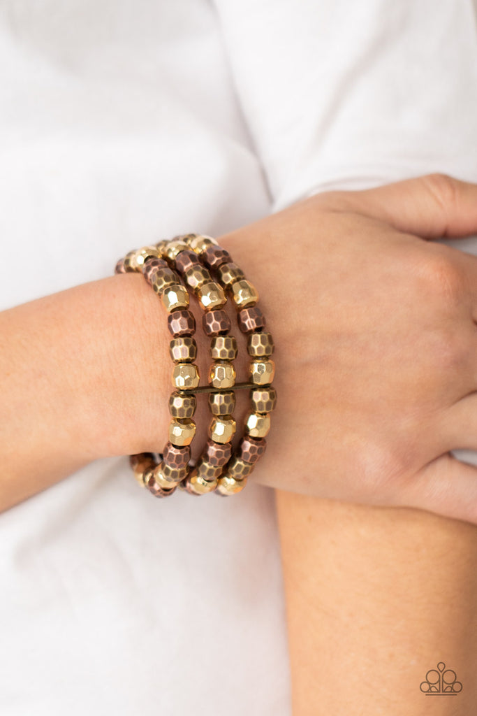 Held together with dainty brass fittings, rows of faceted brass, copper, and gold beads are threaded along stretchy bands around the wrist, coalescing into bold layers.  Sold as one individual bracelet.