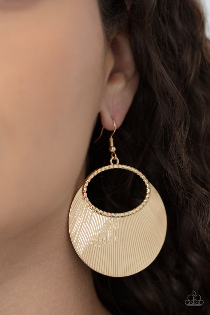 Etched in linear texture, a crescent shaped plate fans out from the bottom of a textured gold oval, coalescing into a blinging metallic display. Earring attaches to a standard fishhook fitting.  Sold as one pair of earrings.