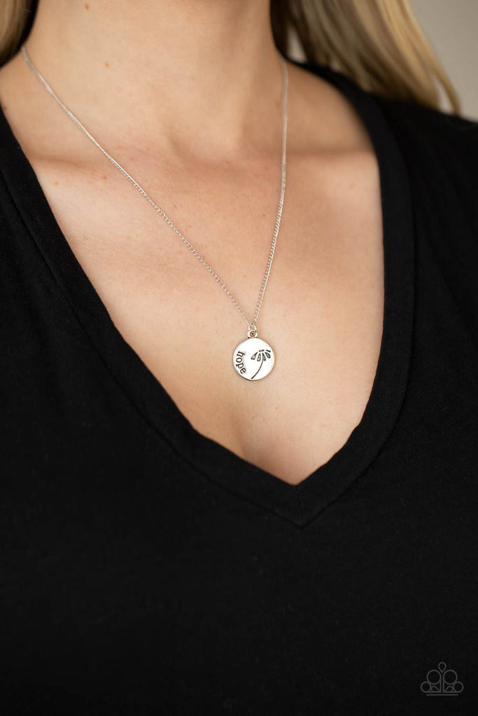 Stamped in a whimsical flower, a dainty silver disc is stamped in the word, "Hope," creating an inspirational pendant below the collar. Features an adjustable clasp closure.  Sold as one individual necklace. Includes one pair of matching earrings.