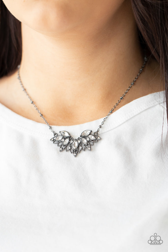 Dotted in a dainty collection of classic round and regal marquise cut rhinestones, airy gunmetal petals fan out below the collar, creating a stunning pendant. Features an adjustable clasp closure.  Sold as one individual necklace. Includes one pair of matching earrings.