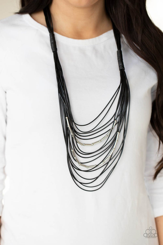 Two rows of dainty silver beads and cylindrical rods are threaded along strands of shiny black cording that has been knotted in place, creating edgy rows across the chest. Features a magnetic closure.  Sold as one individual necklace. Includes one pair of matching earrings.  New Kit