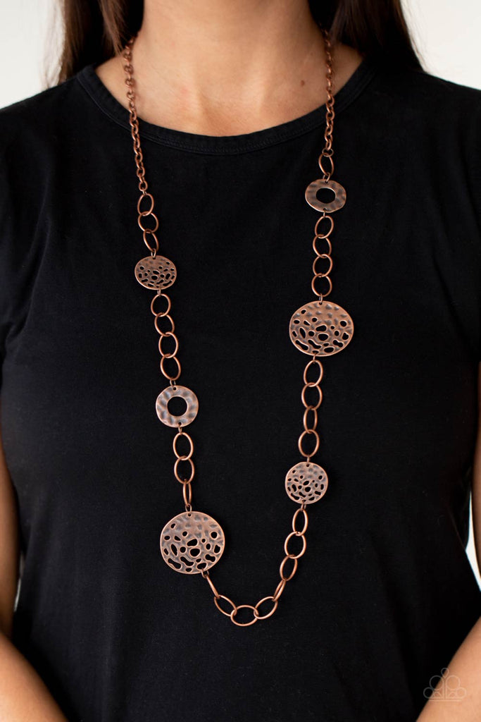 Featuring rustic finishes, hammered copper hoops and holey copper discs link with sections of oversized copper links across the chest for an artisan inspired look. Features an adjustable clasp closure.  Sold as one individual necklace. Includes one pair of matching earrings.
