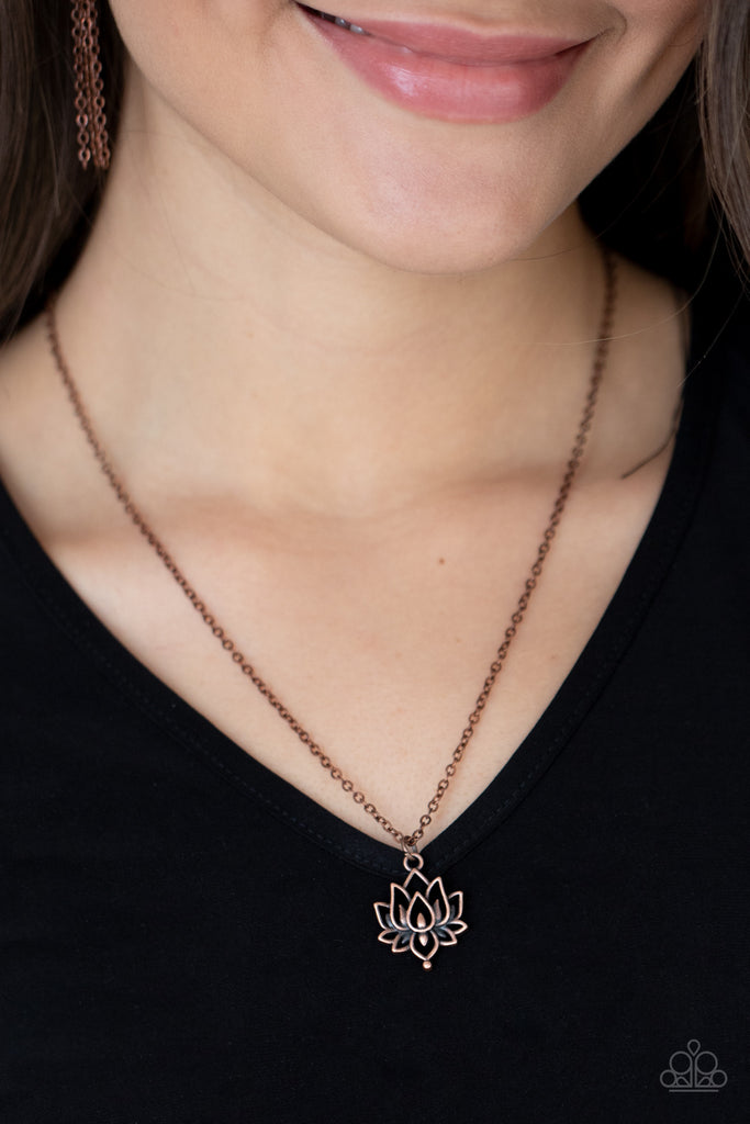 A rustic copper lotus blooms along a dainty copper chain, creating a whimsical pendant below the collar. Features an adjustable clasp closure.  Sold as one individual necklace. Includes one pair of matching earrings.