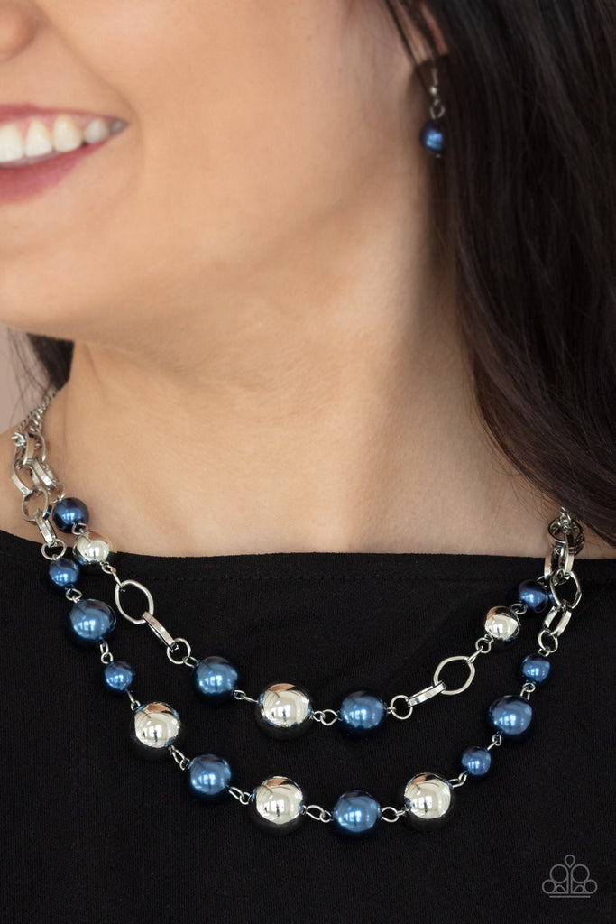 Sections of oversized silver chains, blue pearls, and shiny silver beads haphazardly link into two timeless layers below the collar, creating a dramatically refined display. Features an adjustable clasp closure.  Sold as one individual necklace. Includes one pair of matching earrings.