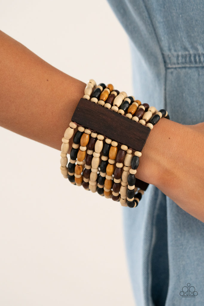 Held together with rectangular wooden frames, an earthy collection of white wooden beads and black, brown, and tan oval wooden beads are threaded along stretchy bands around the wrist for a bold beach inspired fashion.  Sold as one individual bracelet.  