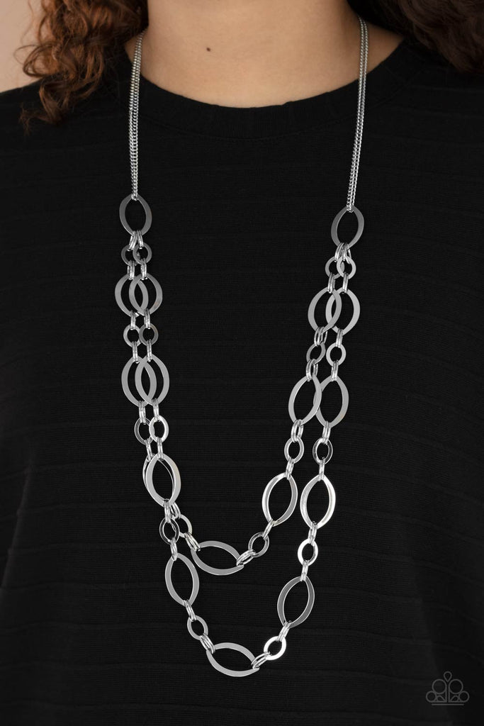 Stunning silver marquise links join together for two layers of bold, basic drama. The layers hang from a simple silver chain adding balance to the scene. Features an adjustable clasp closure.  Sold as one individual necklace. Includes one pair of matching earrings.