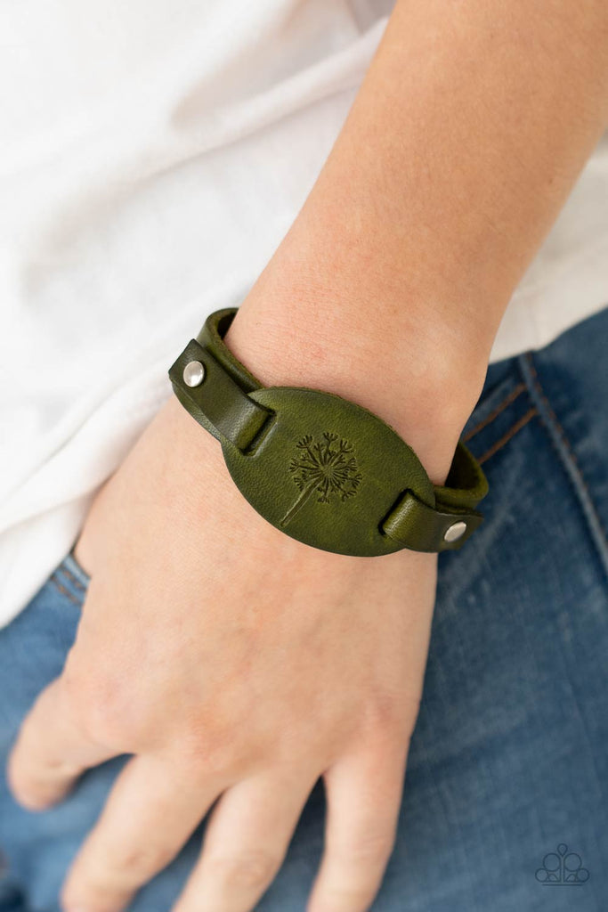 Stamped in a rustic dandelion decoration, a piece of green leather is studded in place across the front of a distressed leather band for a whimsically southern look. Features an adjustable sliding knot closure.  Sold as one individual bracelet.  