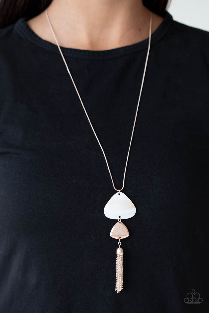 tide-you-over-rose-gold A dainty rose gold tassel sways from the bottom of two triangular discs, one white shell-like and one rose gold, for a flirty pendant at the end of a lengthened rose gold snake chain. Features an adjustable clasp closure.  Sold as one individual necklace. Includes one pair of matching earrings.