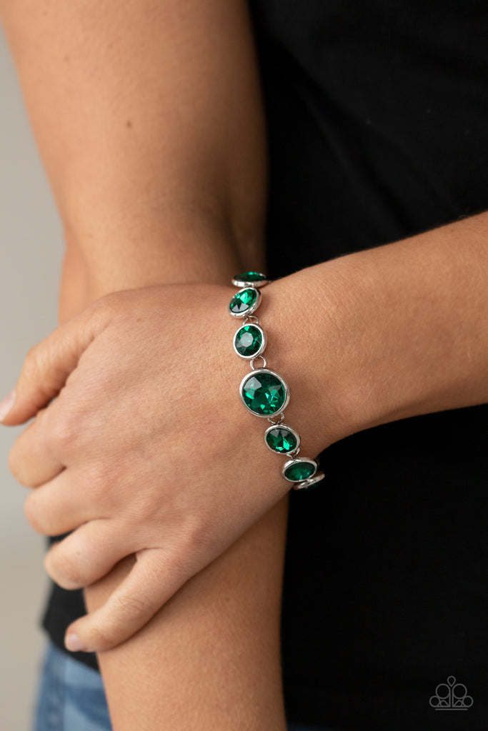 lustrous-luminosity-green Featuring sleek silver fittings, an oversized collection of sparkly green gems delicately link around the wrist. The centermost gem is slightly larger than the rest, adding a glamorous finish. Features an adjustable clasp closure.  Sold as one individual bracelet.