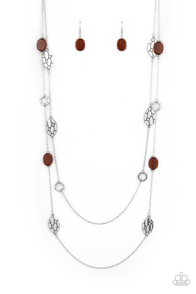 Textured silver links alternate between glassy brown accents and cobblestone patterned silver discs along two shimmery chains, creating whimsical layers across the chest. Features an adjustable clasp closure.  Sold as one individual necklace. Includes one pair of matching earrings.