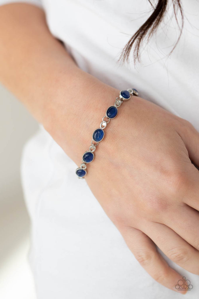 Featuring studded silver fittings, blue cat's eye stone frames delicately connect with ornate silver links around the wrist for an enchanted fashion. Features an adjustable clasp closure.  Sold as one individual bracelet.