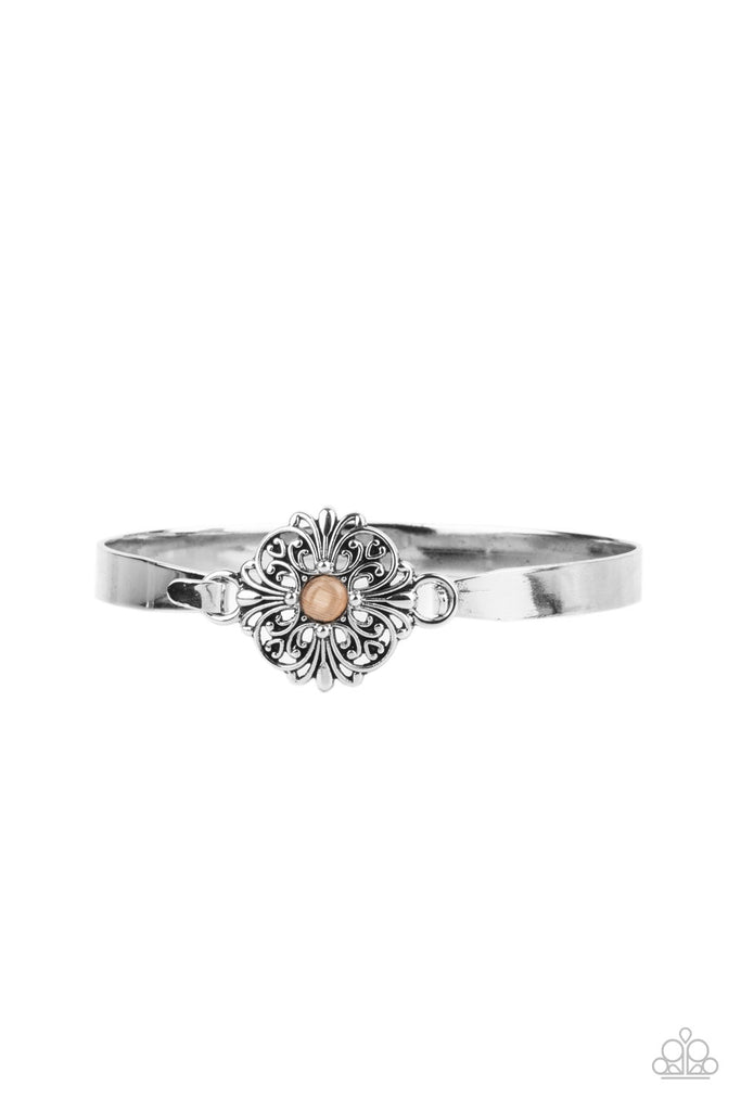 Dotted with a dainty orange cat's eye stone center, a silver floral filigree frame hinges to the center of a dainty silver cuff-like bangle for a whimsical finish. Features a hinged closure.  Sold as one individual bracelet.