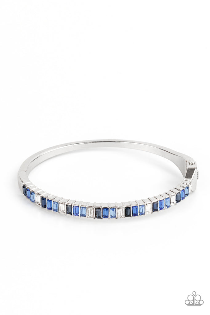 toast-to-twinkle-blue Featuring regal emerald style cuts, a dainty row of blue and white rhinestones are encrusted across the front of a silver cuff-like bangle for a timeless fashion. Features a hinged closure.  Sold as one individual bracelet.