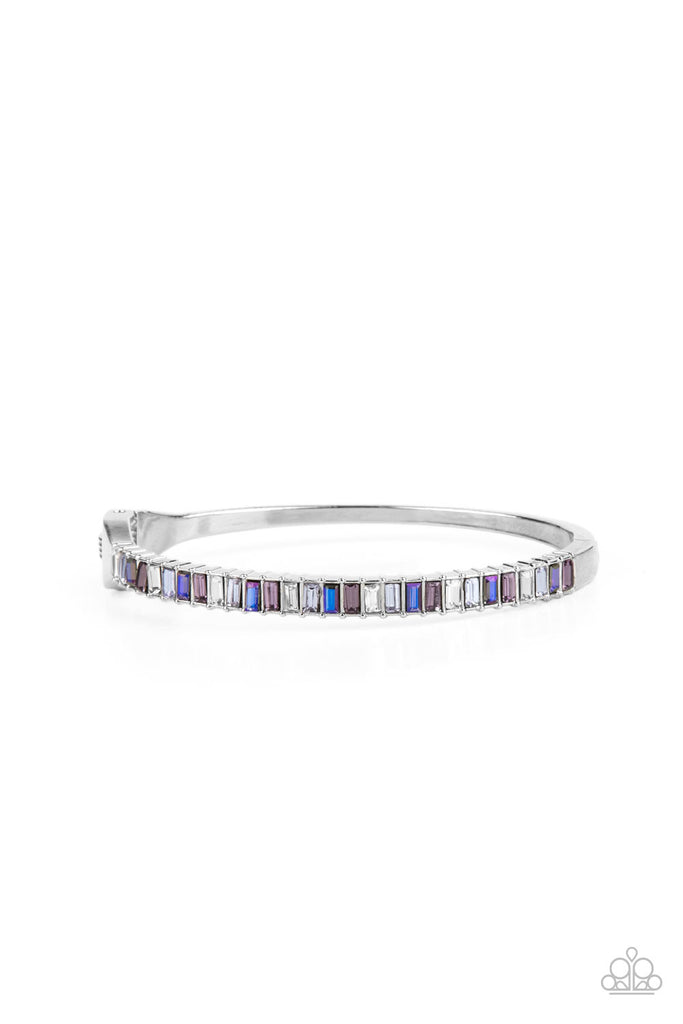 toast-to-twinkle-purple  Featuring regal emerald style cuts, a dainty row of purple, white, and blue rhinestones are encrusted across the front of a silver cuff-like bangle for a timeless fashion. Features a hinged closure.  Sold as one individual bracelet.