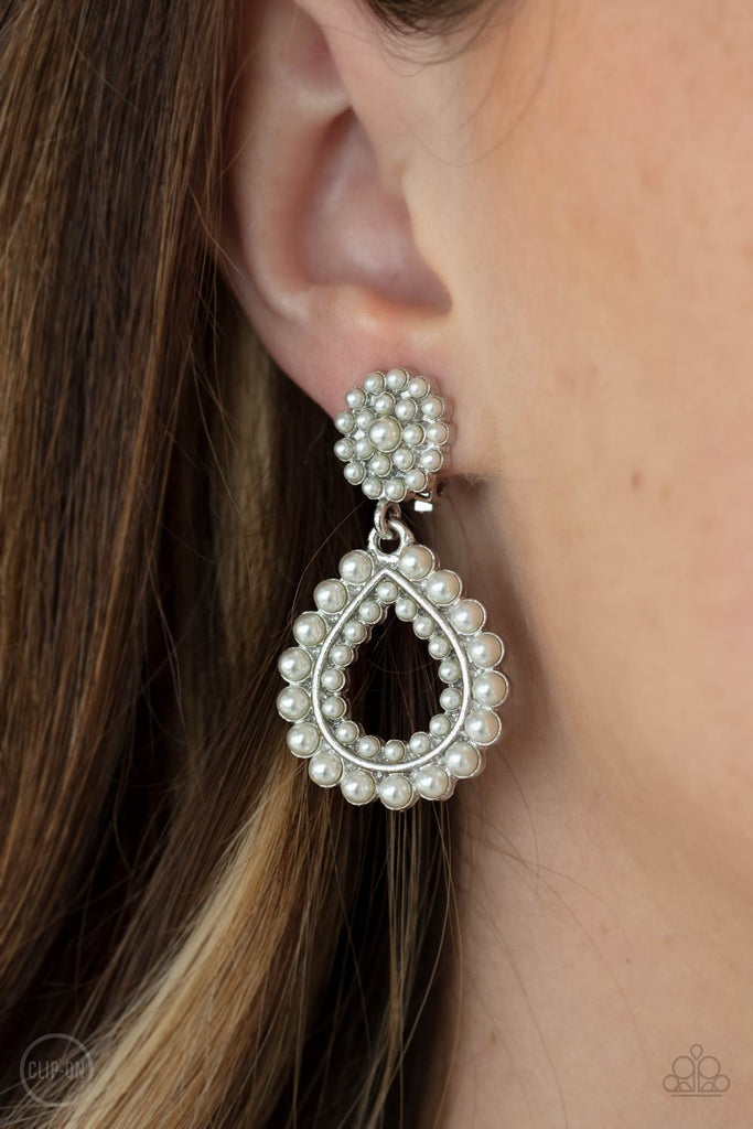 discerning-droplets-white Droplets of pearls dot the surface of a silver teardrop frame that suspends from a round pearl encrusted disc for a classic finish. Earring attaches to a standard clip-on fitting.  Sold as one pair of clip-on earrings.