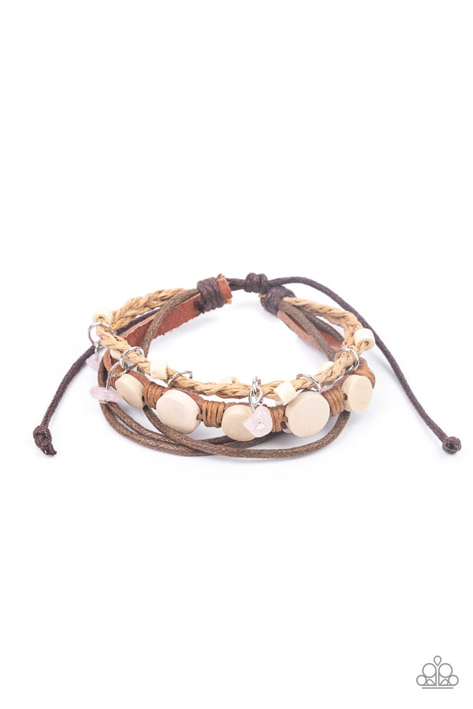 run-the-rapids-pink Assorted strands of cording and leather, featuring flat wooden beads and small pink polished stones dangling from silver fittings, layer across the wrist for an earthy handcrafted style. Features an adjustable sliding knot closure.  Sold as one individual bracelet.