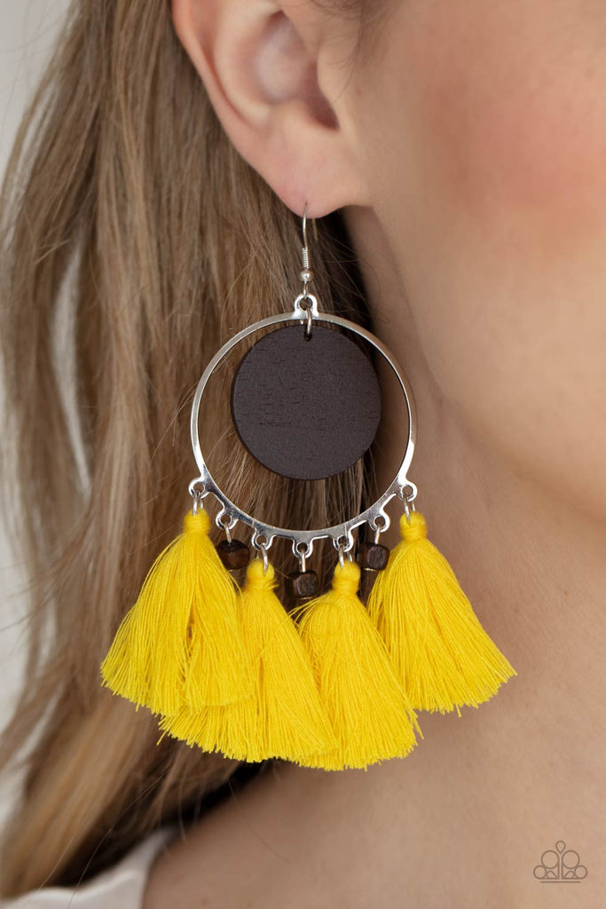 A wooden disc swings from the top of a shiny silver hoop that is adorned in dainty wooden cube beads and Primrose threaded tassels, creating an earthy fringe. Earring attaches to a standard fishhook fitting.  Sold as one pair of earrings.