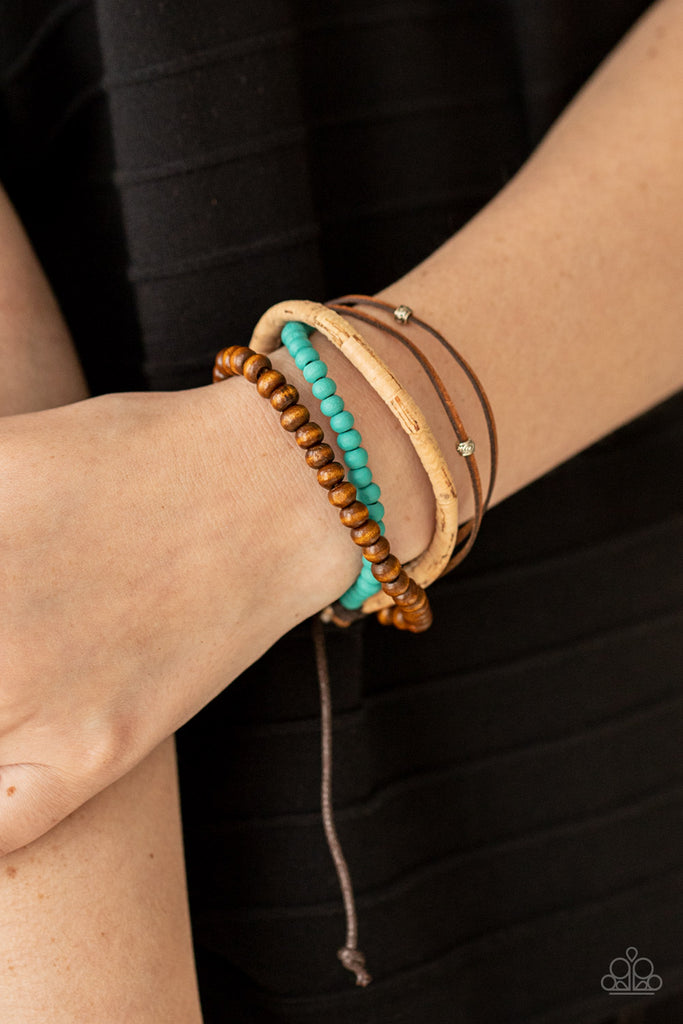 Featuring a strand of turquoise wooden beads, a collection of earthy strands of cork, leather, and wood, comes together for a simple handmade feel as it stacks up the wrist. Features an adjustable sliding knot closure.  Sold as one individual bracelet.