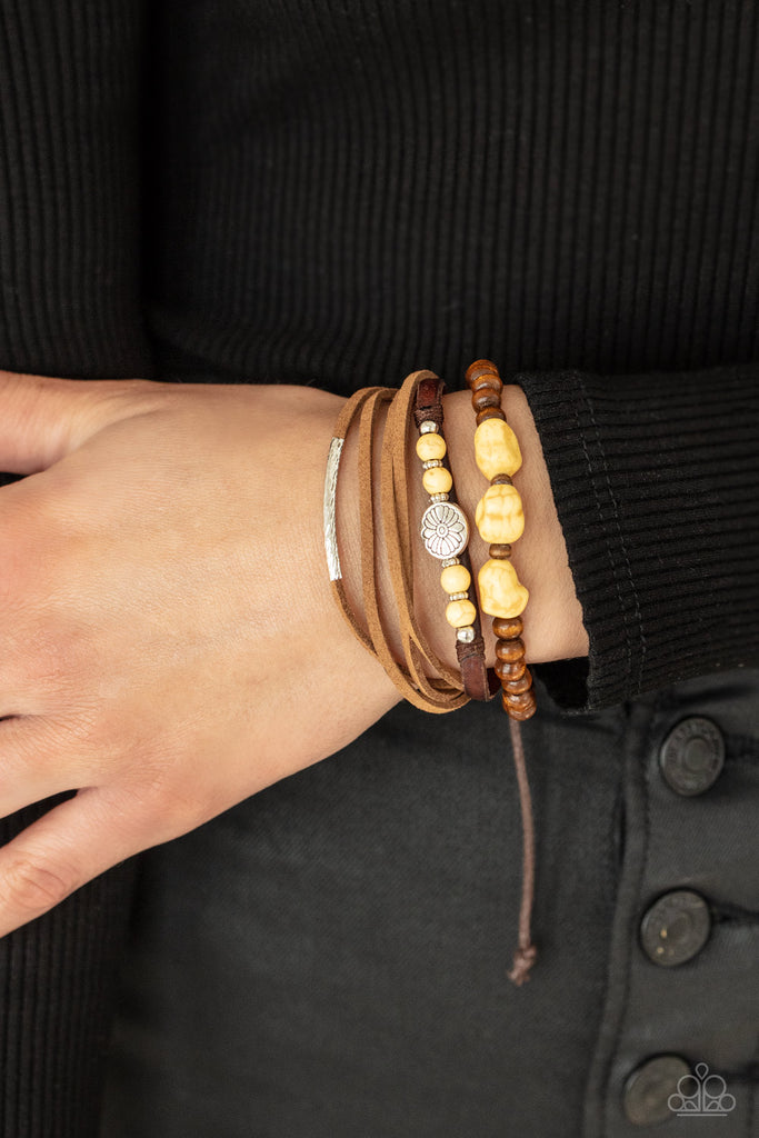 Featuring natural yellow stones and silver accents, a collection of leather strands and wooden beads encircle the wrist in a subtle Southwestern fashion. Features an adjustable sliding knot closure.  Sold as one individual bracelet.