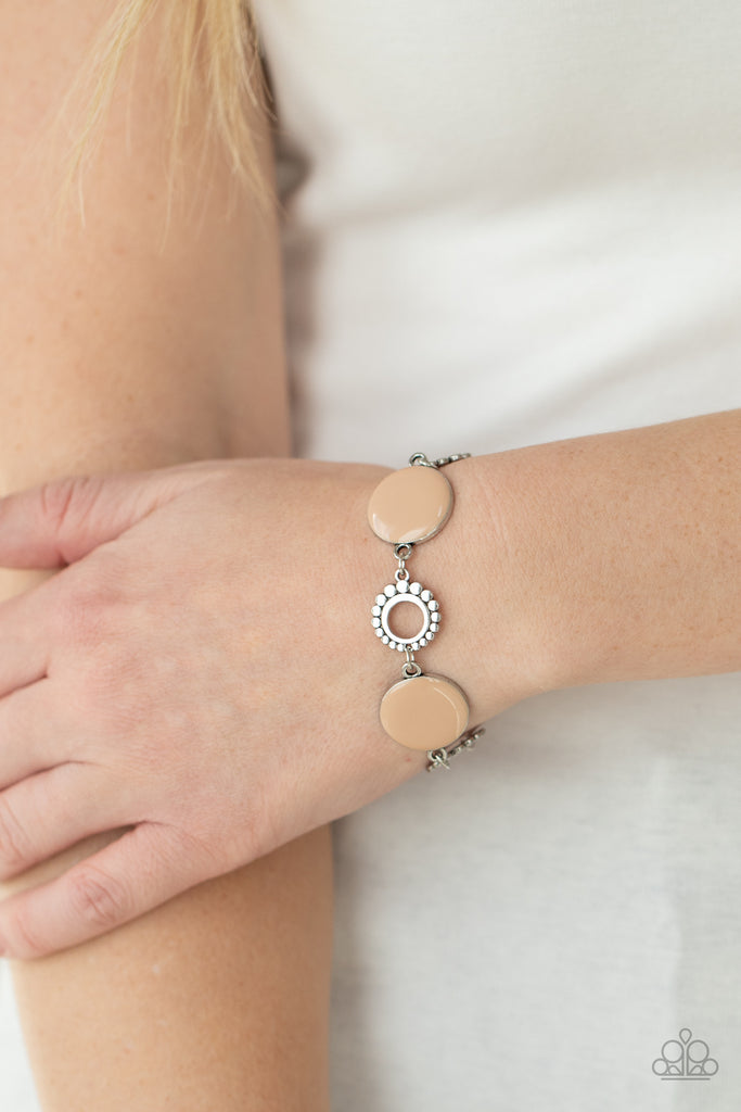 Featuring shiny Desert Mist accents, studded silver circles and shimmery silver floral accents link around the wrist for a colorful display. Features an adjustable clasp closure.  Sold as one individual bracelet.