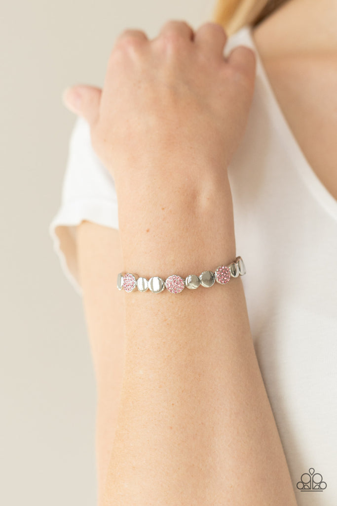 dimensional-dazzle-pink  Glittery pink rhinestone encrusted frames and joined pairs of silver discs are threaded along stretchy bands around the wrist, creating a bubbly centerpiece.  Sold as one individual bracelet.  also available in BROWN with champagne colored rhinestones