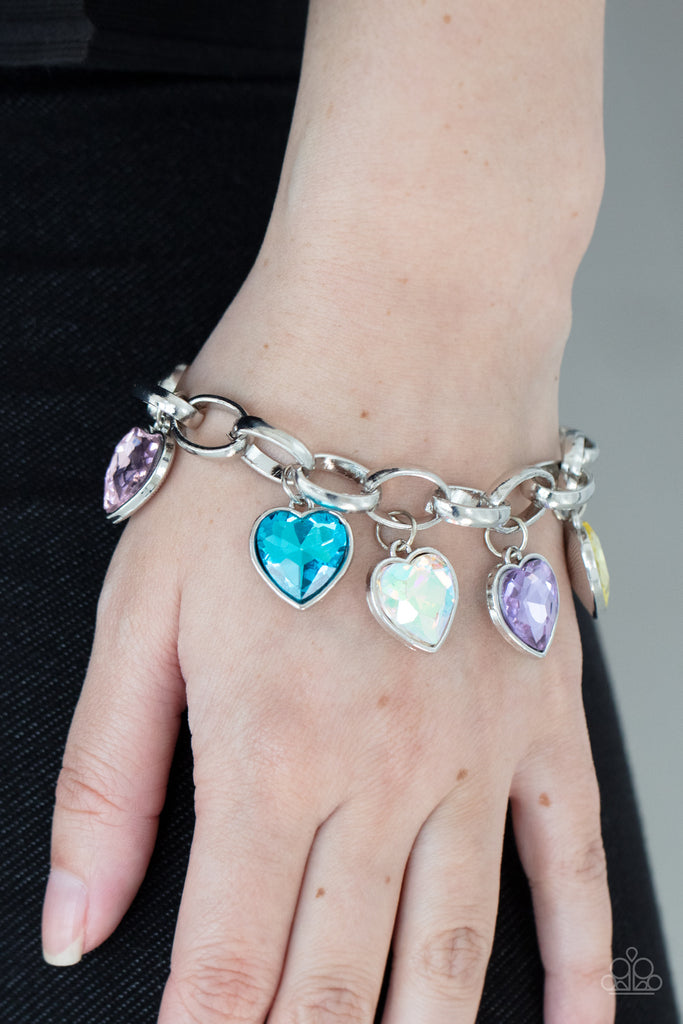 Multicolored heart-shaped gems are encased in sleek silver frames that swing from an oversized silver chain, creating a sparkly fringe around the wrist. Features an adjustable clasp closure.  Sold as one individual bracelet.  New Kit