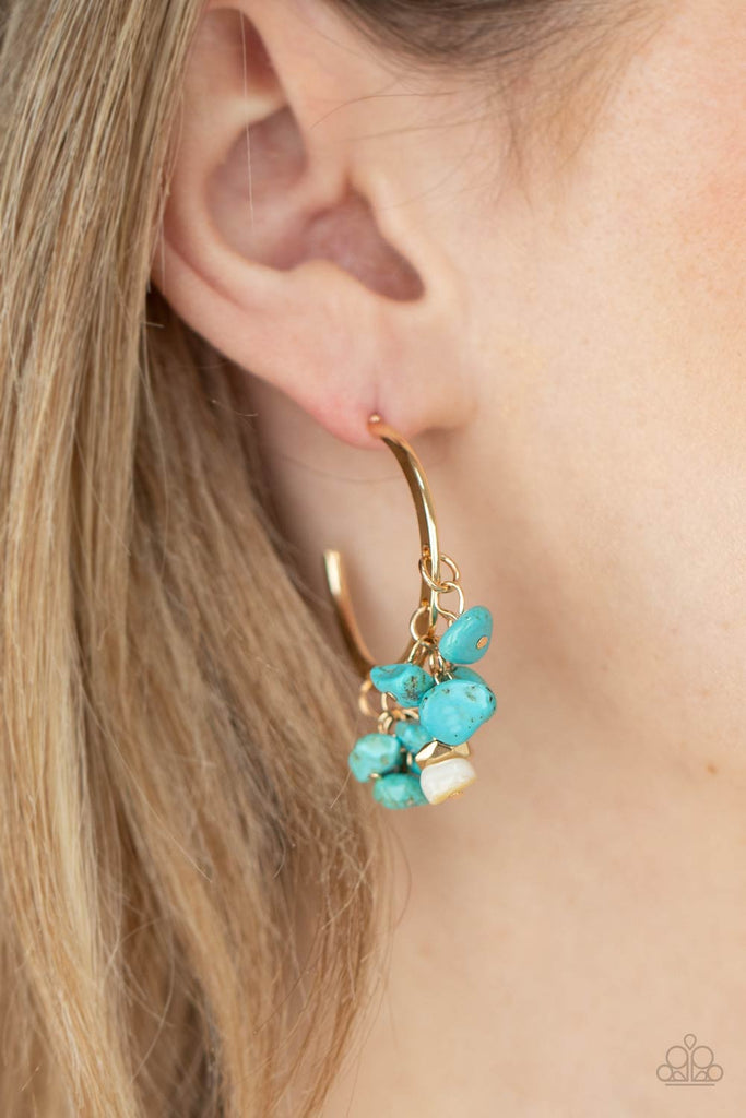 Clusters of turquoise pebbles swing from the bottom of a dainty gold hoop, creating an earthy fringe. A faceted gold and white stone bead swings from the center, adding an ethereal edge. Earring attaches to a standard post fitting. Hoop measures approximately 1 1/4" in diameter.  Sold as one pair of hoop earrings.