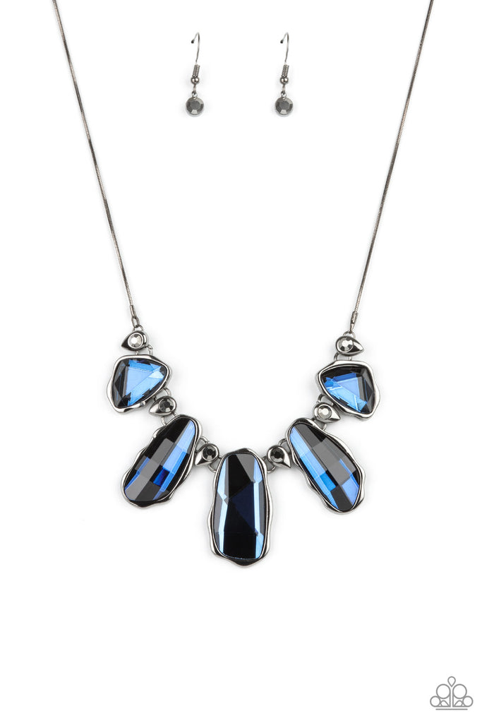 A glittery collection of raw cut blue gems delicately link with dainty hematite rhinestone dotted gunmetal teardrops below the collar, creating a stellar fringe. Features an adjustable clasp closure.  Sold as one individual necklace. Includes one pair of matching earrings.