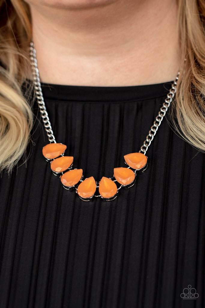 Dewy orange teardrop gems are nestled inside pronged silver frames that delicately connect below the collar, creating an ethereal centerpiece. Features an adjustable clasp closure.  Sold as one individual necklace. Includes one pair of matching earrings.  