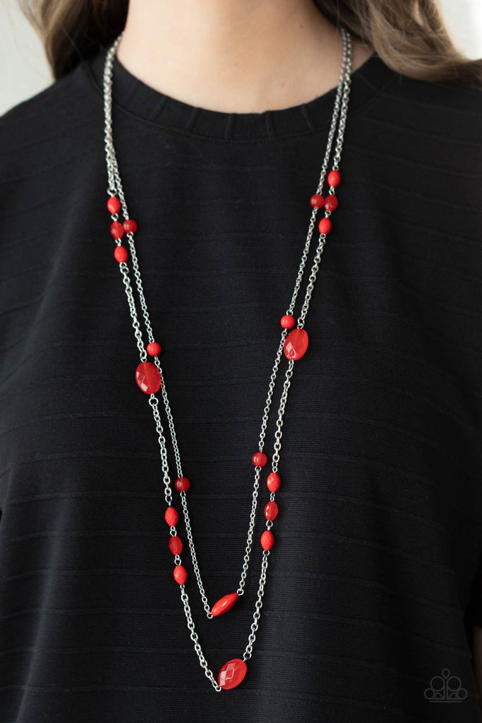 A pair of lengthened silver chains are accented with bright red faceted beads in varying sizes for a delightfully whimsical display. Features an adjustable clasp closure.  Sold as one individual necklace. Includes one pair of matching earrings.