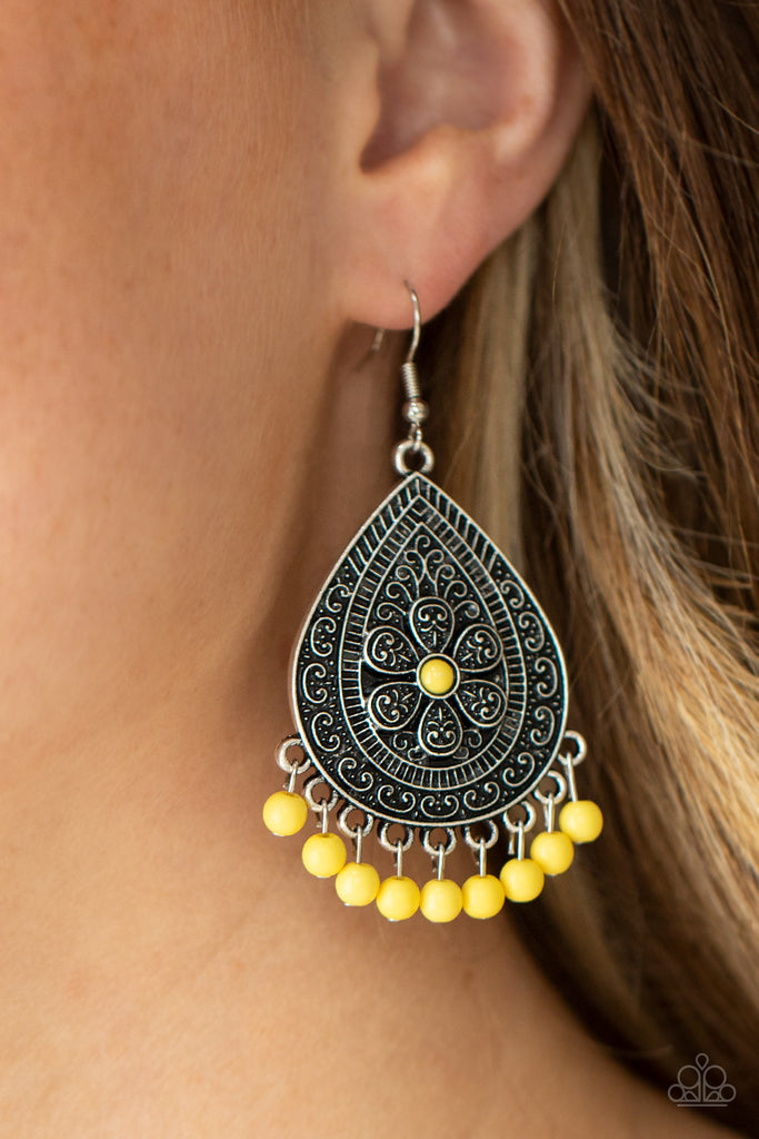 Dotted with a dainty yellow bead, a silver flower is surrounded by an antiqued silver filigree teardrop frame. A row of yellow beads at the bottom of the teardrop adds color and fun for a playful look. Earring attaches to a standard fishhook fitting.  Sold as one pair of earrings.