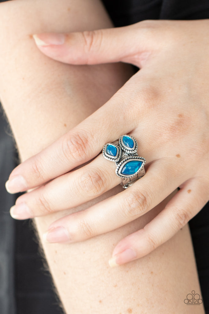 A trio of glassy blue marquise beads embellish the front of a hammered silver band etched in faux layers, creating an ethereal display atop the finger. Features a stretchy band for a flexible fit.  Sold as one individual ring.  