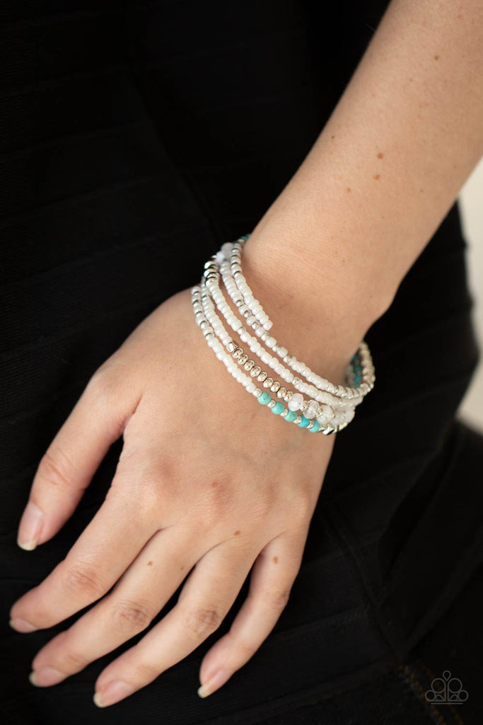 Sections of iridescent white seed beads alternate with silver, turquoise, and cloudy acrylic beads in infinite rows. The dreamy colors are threaded along a continuous strand of wire for an infinity wrap-style bracelet around the wrist.  Sold as one individual bracelet.