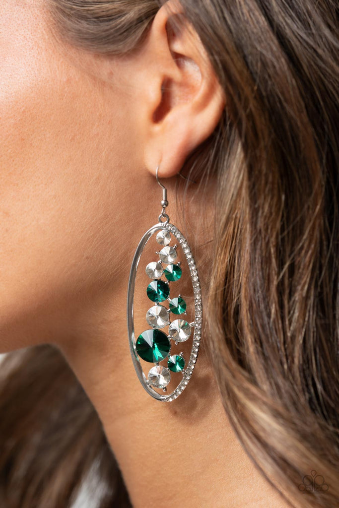 An oversized collection of glassy white and glittery green rhinestones sparkle inside a silver oval frame. One side of the frame is encrusted in dainty white rhinestones, adding a refined flair to the bubbly lure. Earring attaches to a standard fishhook fitting.  Sold as one pair of earrings.