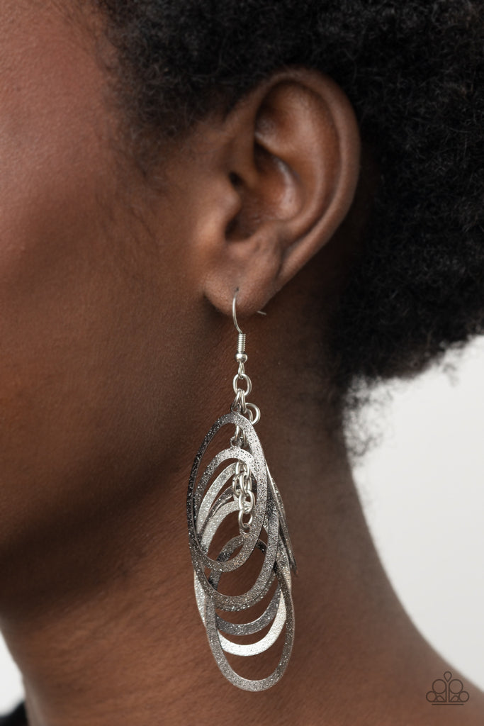 Featuring a hammered high sheen finish, flat silver and gunmetal ovals cascade from the ear, creating a flattering tassel. Earring attaches to a standard fishhook fitting.  Sold as one pair of earrings.