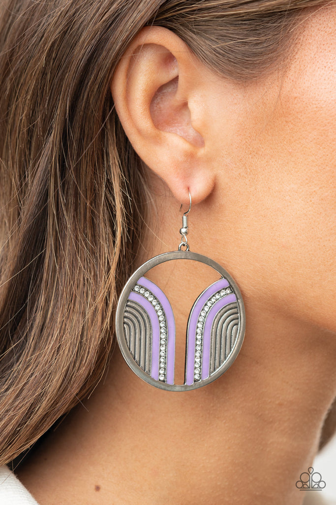 Infused with a glittery row of white rhinestones, shiny purple arcs curve into juxtaposed frames inside a classic silver hoop, creating a colorful art deco inspired centerpiece. Earring attaches to a standard fishhook fitting.  Sold as one pair of earrings.