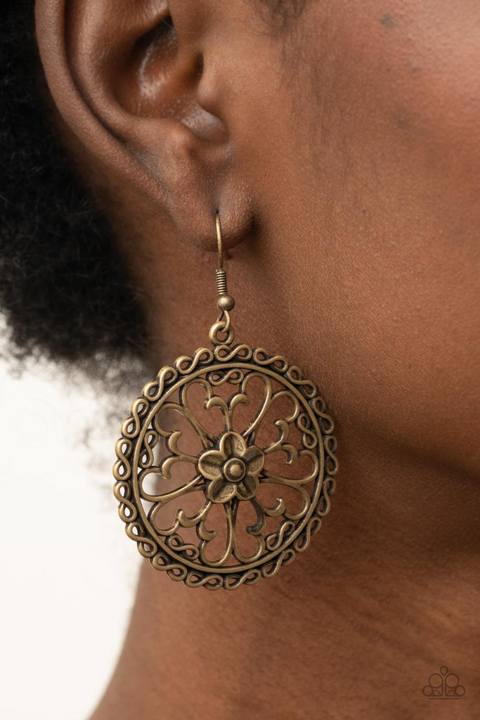 Airy butterfly shaped brass frames fan out from an antiqued brass flower, creating a whimsical centerpiece inside a hoop of dainty brass infinity accents. Earring attaches to a standard fishhook fitting.  Sold as one pair of earrings.