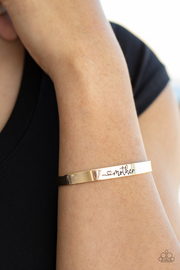 A dainty gold cuff is stamped in a heart and the word, "Mother," creating a sentimental centerpiece around the wrist.  Sold as one individual bracelet.